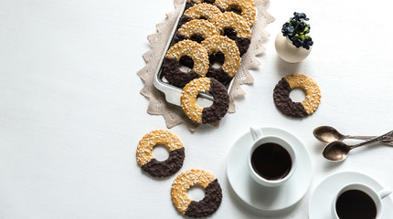 Chocolate cookies with two cups of coffee