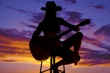 silhouette of a woman with a guitar sit play