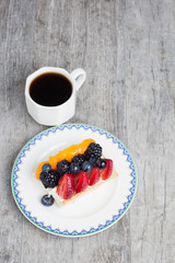 Slice of fruit tart with coffee