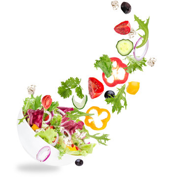 Fresh salad with flying vegetables ingredients