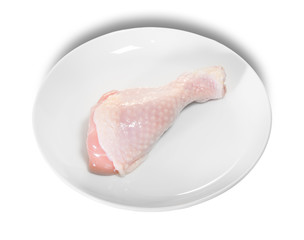 Single Raw Chicken Legs On White Plate