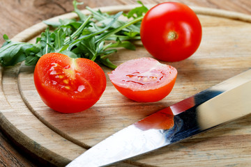 Tomatoes salad a knife on a chopping board