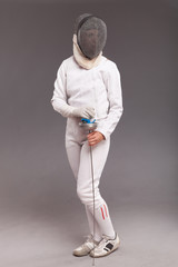 girl in white fencing costume. with sword and  fencing mask 