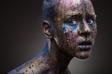 Portrait of girl in paints. Body art and face art
