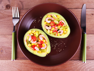 Tasty salad in avocado on plate table close-up