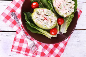 Tasty salad in avocado on plate table close-up