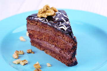 Delicious chocolate cake on plate on table close-up
