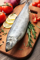 Fresh raw fish and food ingredients on table