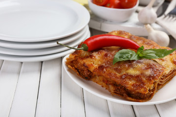 Portion of tasty lasagna on table
