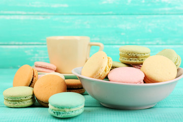 Assortment of gentle colorful macaroons in colorful bowl and