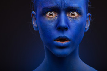 art photo of a beautiful woman with blue face