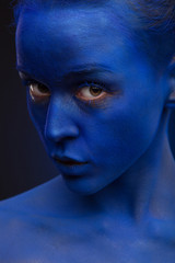 art photo of a beautiful woman with blue face