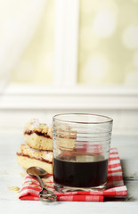 Glass of espresso and tasty homemade pie on wooden table