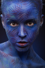 art photo of a beautiful woman with blue face