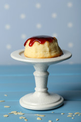Delicious cheesecake on table, on color background