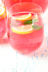 Pink lemonade in glass on table close-up