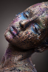 Beautiful face of a woman covered in glitter. Face art. Sexy