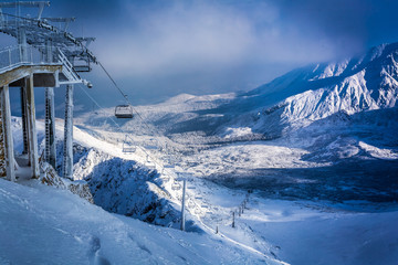 Snow covered mountain valley at dawn the sun