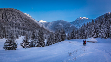 Winter expedition in the mountains at sunset