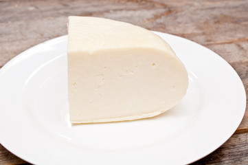 soft goat cheese in a bowl on a wooden table