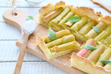 Slices of pie with rhubarb on a cutting board