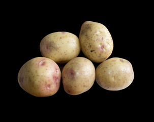 Five raw potatoes isolated on black.