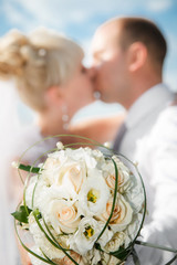 beautiful bouquet of the bride  with the wedding kissing couple
