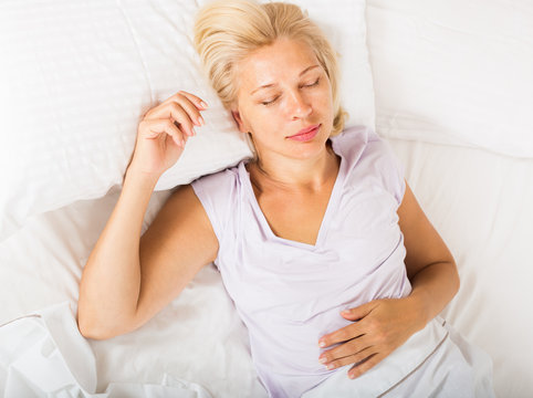 Middle-aged Woman Sleeping In Bed