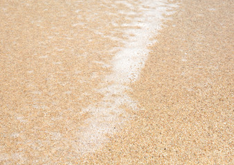 Fototapeta na wymiar Sand and seafoam