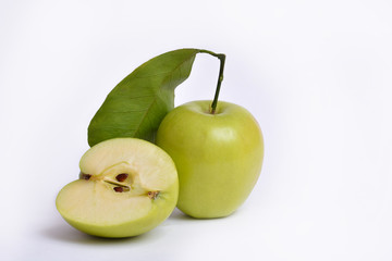 Green apples cut in two slices with leave, on white background