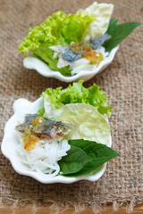 Fried mackerel served with boiled thai rice vermicelli.