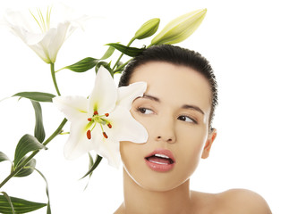 Woman with healthy skin and lily flower