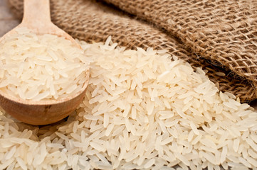 rice from the bag and wooden spoon