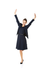 Young happy businesswoman with hands up