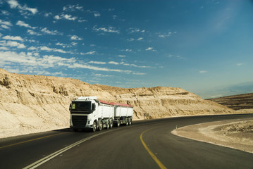Trac driving on desert road.