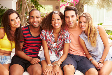 Group Of Friends Relaxing Outdoors On Holiday Together