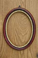 vintage empty oval picture art frame on oak plank