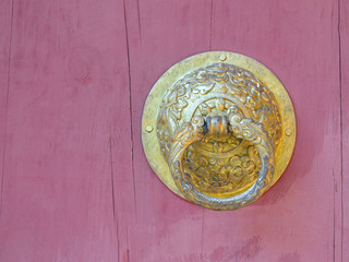 bhutan style metal door knob on wooden background
