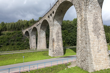 Fototapeta na wymiar Stone railway viaduct with a length of 120 meters