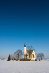 Fototapeta na wymiar Winter landscape with a church, Poland.