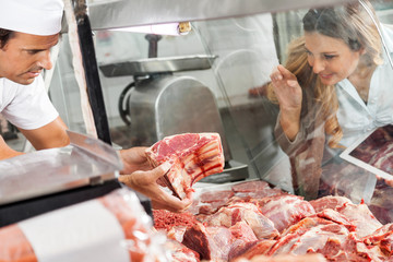 Woman Buying Meat At Butchery