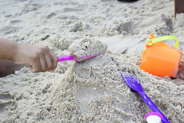 Fototapeta na wymiar Children playing toy on sand
