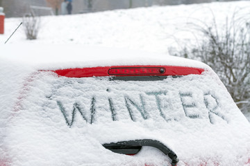 The inscription "Winter" on a car windshield.