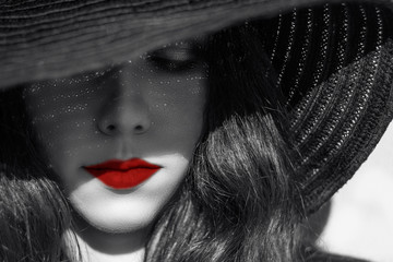 Mysterious sexy woman in black hat. Red lips.