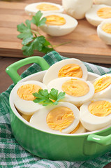 Boiled eggs in a bowl decorated with parsley leaves