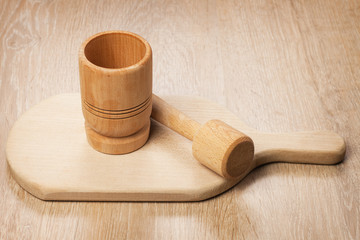 wooden mortar and breadboard on the table