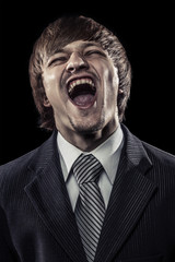 young successful businessman laughing hard over black
