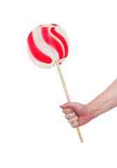 Hand holding candy cane lollipop
