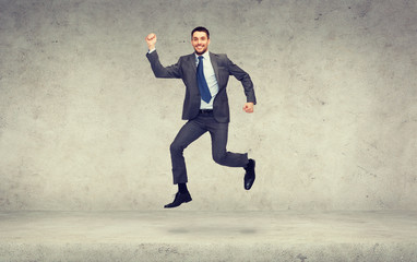 smiling businessman jumping