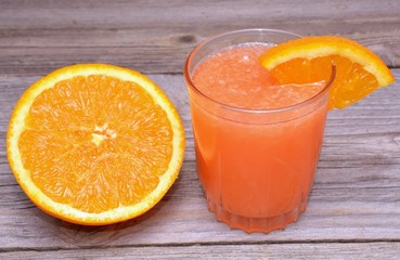 Fresh orange juice on wooden table